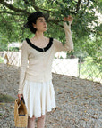 17a36 Off-shoulder knit top with ruffled neckline